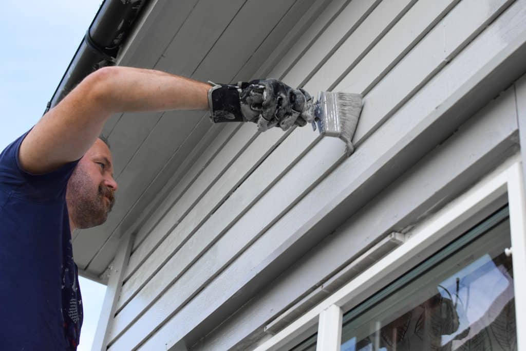 Man painting house exterior